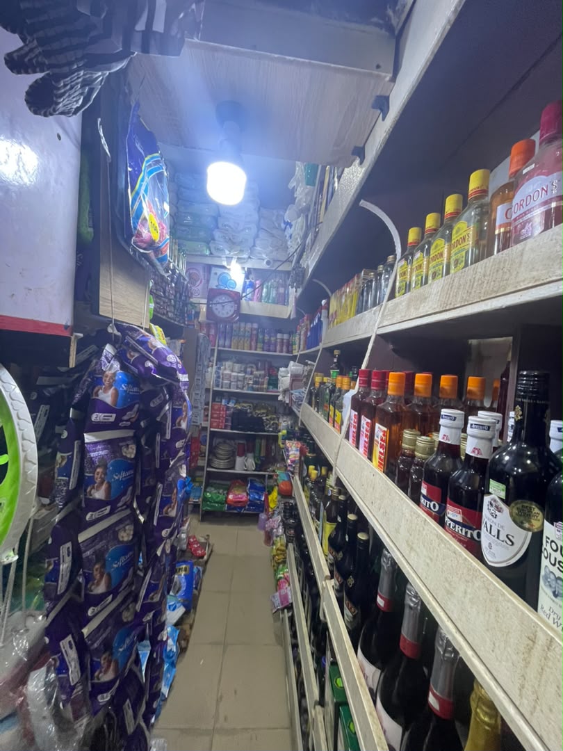 Interior aisle with household goods and spirits shelves