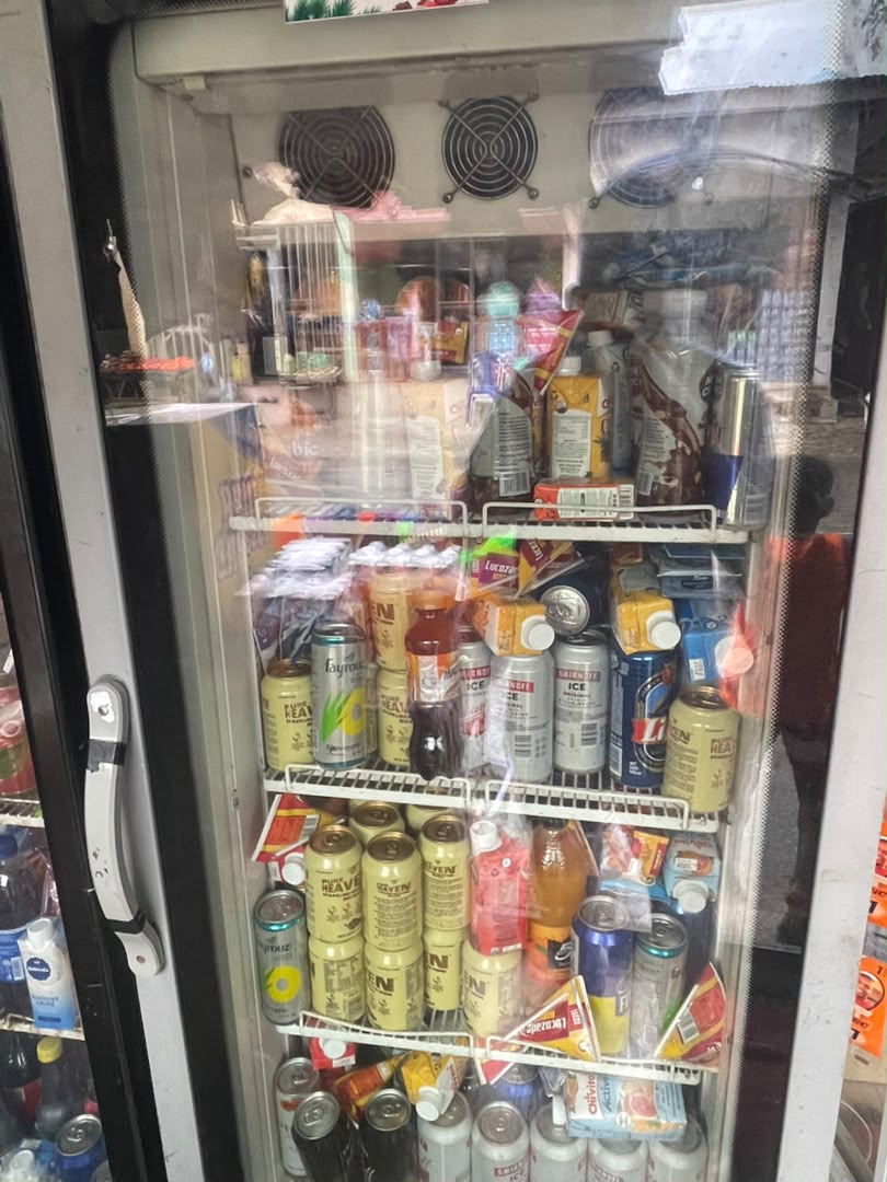Drinks fridge filled with soft drinks, juices and energy drinks