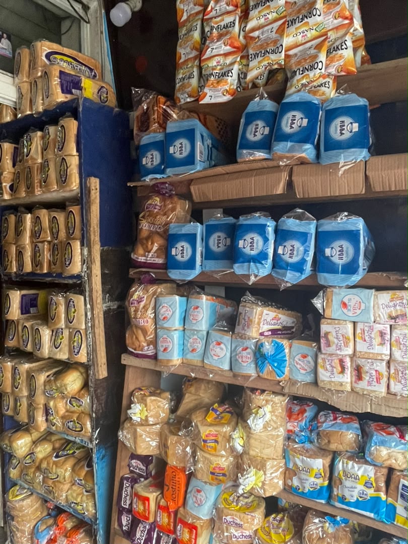 Shelves stacked with loaves of bread and cornflakes